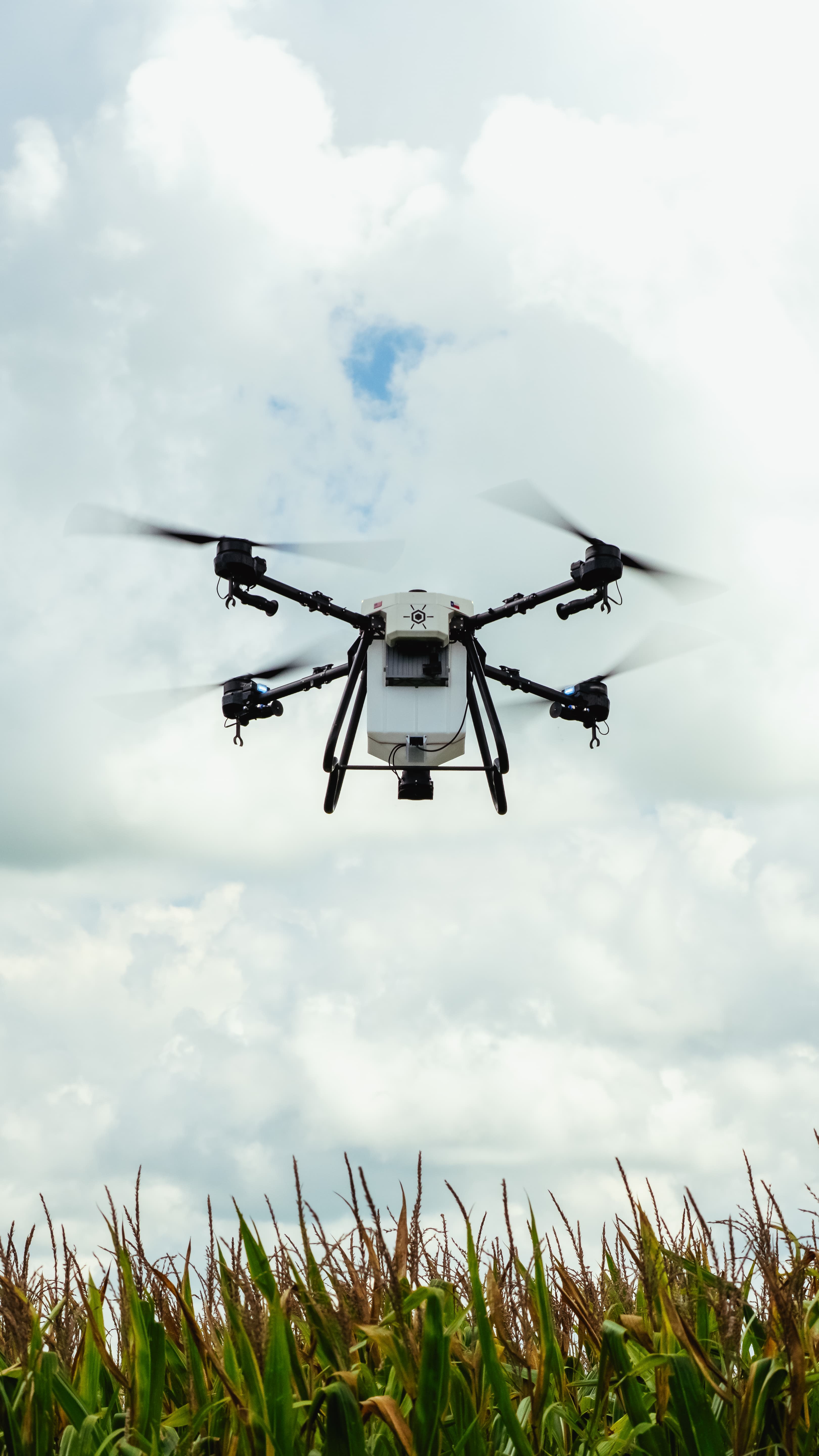 Hylio agricultural spray drone spraying a field